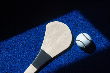 Hurling bat and sloitar on blue background. Horizontal sport theme poster, greeting cards, headers,...
