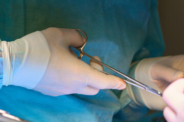 surgical instruments in the hands of a doctor close-up