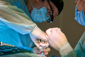 surgical instruments in the hands of a doctor close-up