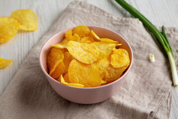 Crunch Green Onion Potato Chips in a Pink Bowl, side view.