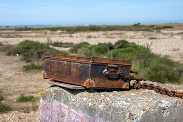 Chained rusty metal case in Dungeness