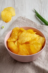 Crunch Green Onion Potato Chips in a Pink Bowl, side view.