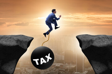 Concept of tax burden with businessman over chasm