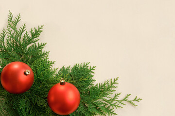 Red Christmas balls and coniferous leaves background.