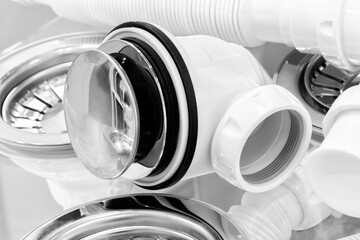 Plumbing sanitary white plastic sewer pipes siphons overflows for bathroom and sink.