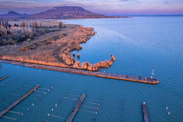 The harbour and pier of Szigliget on the northern coast of the Lake Balaton, Hungary with the Badacsony Mountain in the background 