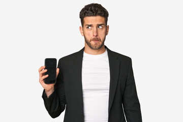 Young business caucasian man confused, feels doubtful and unsure.