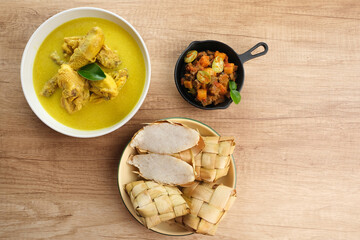 Opor Ayam, served with ketupat, sambal goreng ati, keripik kentang and emping. Popular during Eid al Fitr. Indonesian traditional food
