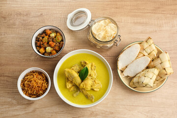 Opor Ayam, served with ketupat, sambal goreng ati, keripik kentang and emping. Popular during Eid al Fitr. Indonesian traditional food
