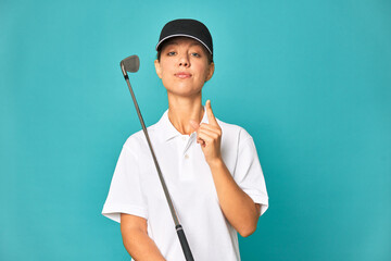A young caucasian golfer woman showing number one with finger.
