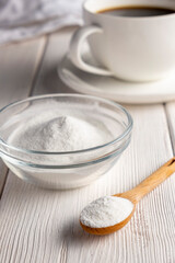 Fototapeta na wymiar Herbal sweetener stevia in spoon and a cup of coffee