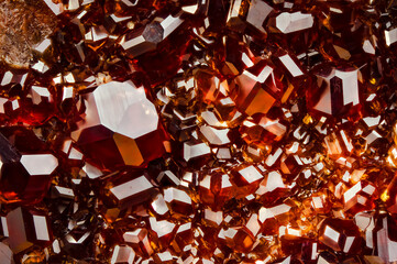 grossular (red garnet) cluster. macro detail texture background. close-up raw rough unpolished semi-precious gemstone