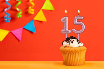 Birthday cake with number 15 candle - Sparkling orange background with bunting