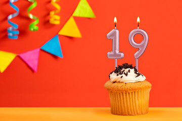 Birthday cake with number 19 candle - Sparkling orange background with bunting