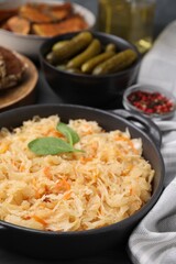 Serving pan with sauerkraut on table, closeup