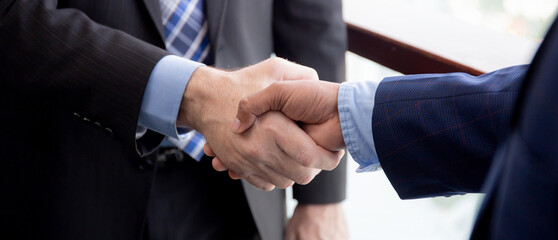 Closeup hands of businessman handshake with partner at office, business man negotiation and agreement for success and shaking hands, executive congratulations and greeting partnership for friendship.