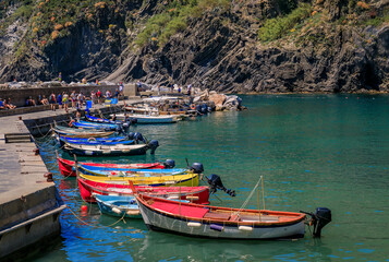 Colorful boats docked on the Mediterranean Sea in Cinque Terre, Vernazza, Italy - obrazy, fototapety, plakaty