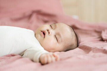 Fototapeta na wymiar image of a newborn baby lying on a pink bed