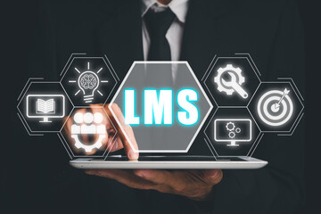 LMS, Learning Management System concept, Business person using tablet with LMS icon on virtual...