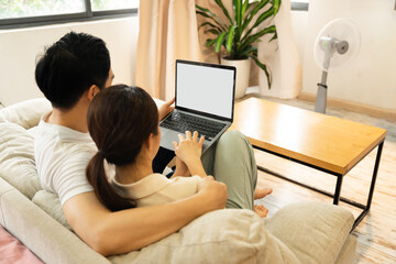 image of asian couple sitting on sofa at home