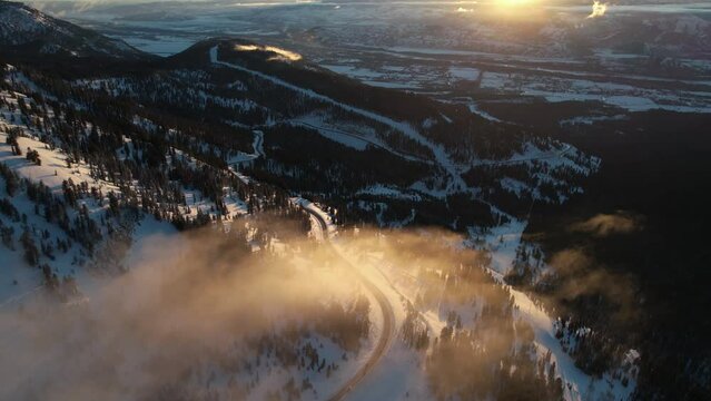 Teton Pass Wyoming pn Winter Sunset, Aerial View of Snowy Landscape and Clouds Above Road