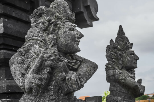 Traditional Balinese statues made of stone carvings in the form of gods, people or demons. Balinese sculpture in temple.