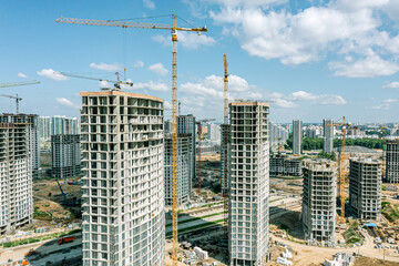 building cranes on a construction site, and high-rise buildings under construction. drone photography.