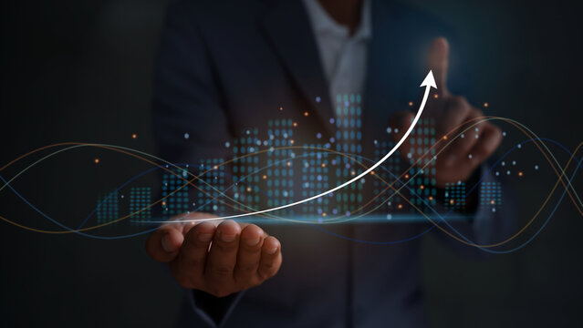 Businessmen touching the virtual screen with the stock market changes, business growth investment bar chart, and more candlesticks connected to trade data, businessmen pointing the arrow.