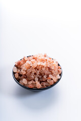Fototapeta na wymiar Himalayan pink salt is herb seasoning from himalaya and isolated on white background with copy space