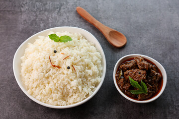 Mutton or Beef biryani Ghee rice. Gosht or lamb biryani Hyderabadi Dum biriyani with raita yoghurt dip. Special occasion festival food for Ramadan Eid Easter Christmas Kerala Hyderabad India.