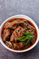 Spicy beef curry. Goan style beef vindaloo. Traditional Indian Lamb or beef curry . spicy Beef curry gravy popular in Kerala Sri Lankan Goa for Appam, Parotta porotta in India.