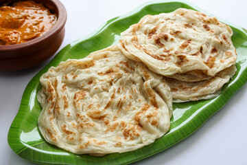 Fish curry with Kerala parathas porotta roti parotta barotta naan layered flatbread made from maida...