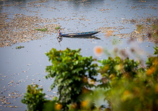 People collect trash that can be recycled and traded from the sea of garbage in the Citarum River, Bandung, Wes Java. Citarum River is the one of polluted river in Indonesia. 