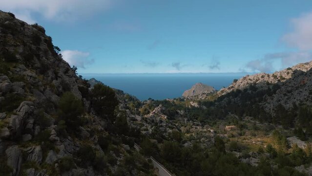 Palma de Mallorca Sa Calobra Port de Soller mountain tops. Green vibrant hills, blue seaside sky sunset horizon. Scenic Majorca Island mountain ridge peak nature aerial drone footage. Cinematic 4K UHD