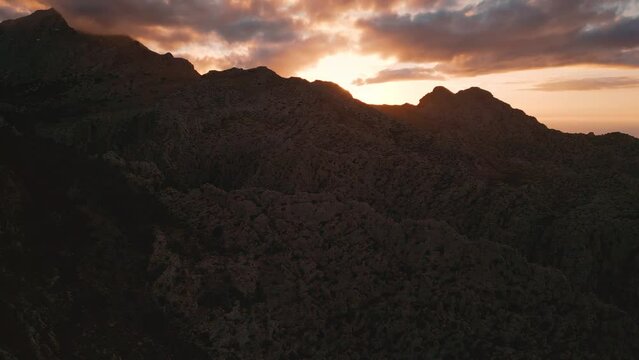 Palma de Mallorca Sa Calobra Port de Soller mountains. Green hills, blue seaside sunset sky horizon. Scenic idyllic Majorca Island mountain ridge peak nature aerial drone footage. Cinematic 4K UHD