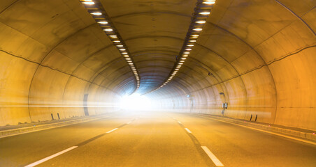 Highway road tunnel with car light