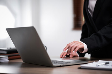 Businesswoman hand working on laptop computer at work place. Business concept