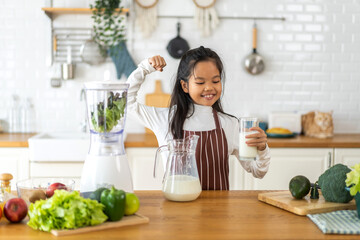 Obraz na płótnie Canvas Portrait of enjoy happy little asian child girl smiling having protein breakfast drinking and hold glasses of fresh milk,healthy nutrition,calcium and vitamin,dairy product,strong and growth 