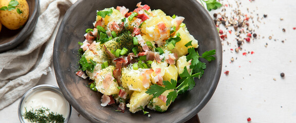 Kartoffelsalat - traditional German potato salad. Potato salad with bacon.