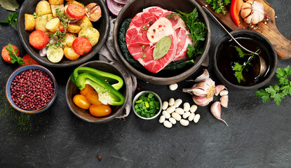 Metal spoon and food ingredients on dark background. Health cooking concept.