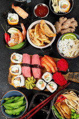 Traditional Japanese food dishes on black background