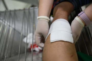 Nurses are treating a bleeding wound on the leg caused by an accident