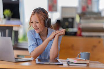 Young student who learns with online platform at coffee shop or co-working space 