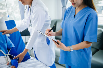 Hospital Ward Male and  Male Professional Asian Doctors Talk with a Patient, Give Health Care Advice, Recommend Treatment Plan  with Advanced Equipment