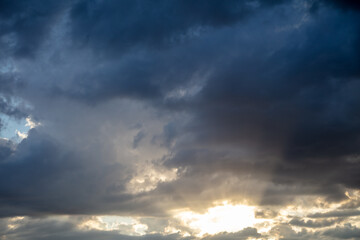 Obraz premium Thunderclouds in the sky at sunset.