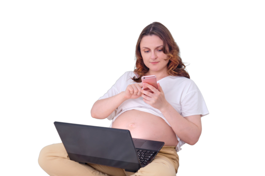 Smiling pregnant woman looking at mobile phone screen while working via internet, isolated on a white background - Powered by Adobe