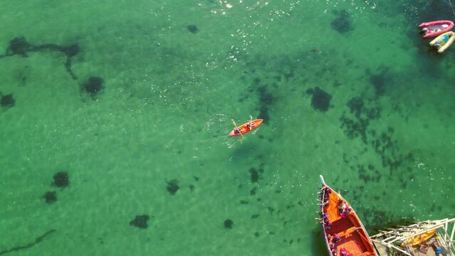 Aerial Drone Fly Above Sea Kayak Paddling in Transparent Sea Water of Pejerrey Beach, Chile, People Enjoying Water Sports in Turquoise Pristine Destination