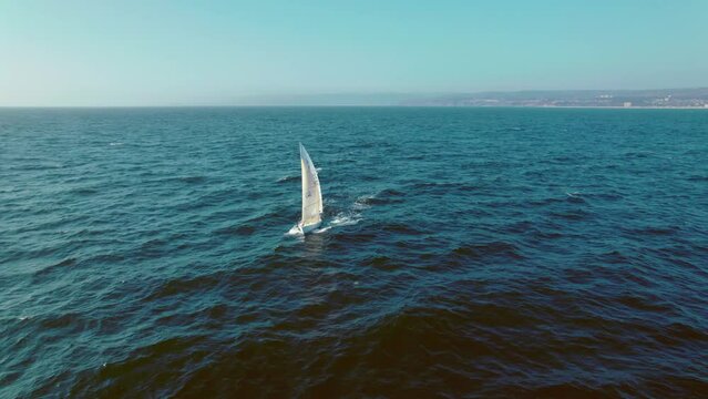 Lonely Sailboat Sails the Blue Waving Waters at Pejerrey Beach, Algarrobo Chile, Aerial Panoramic View During a Sunny Clear Day Above the Sea