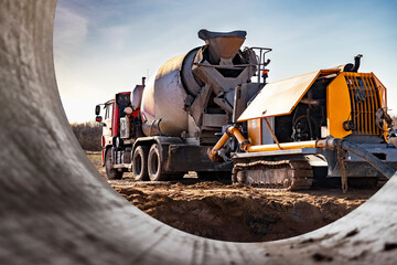 Concrete mixer truck delivers concrete to the pump for pouring piles. Concrete pump at the construction site. Close-up of concrete delivery.