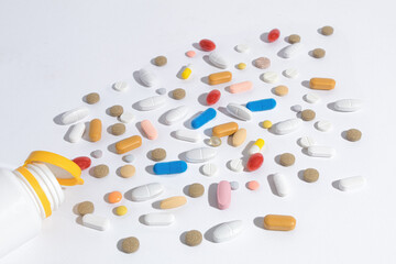 Tablets of different shapes and colors are scattered on the table